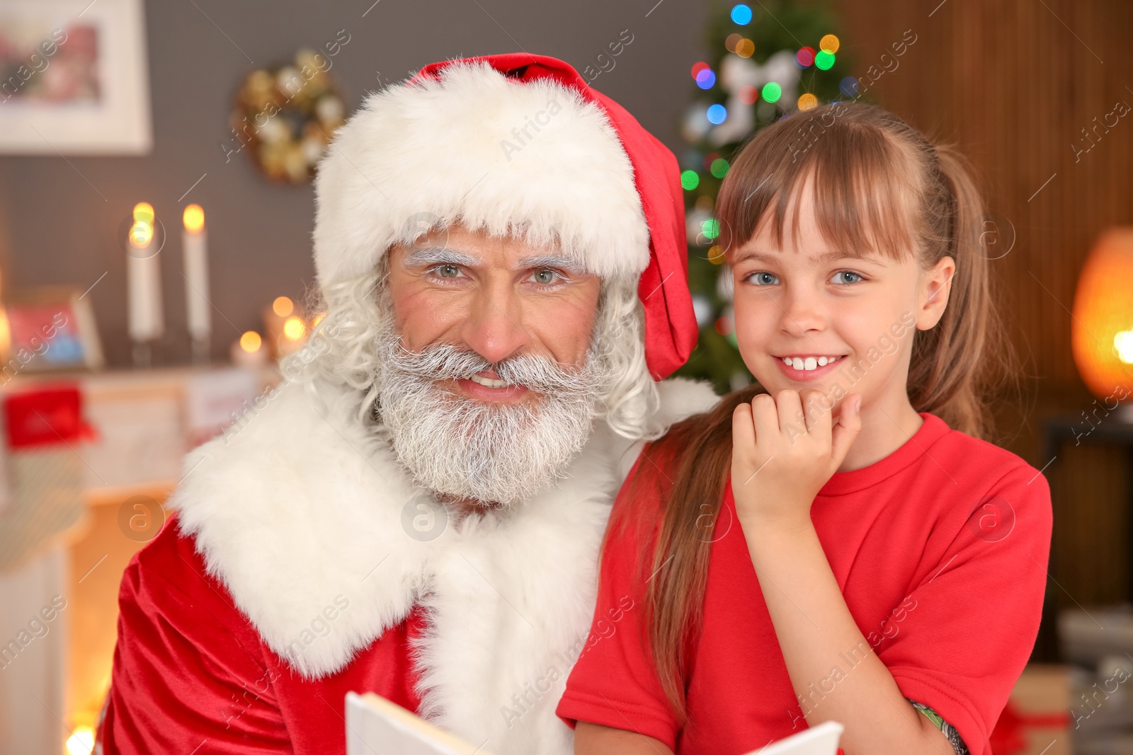 Photo of Portrait of little child with Santa Claus at home. Christmas celebration