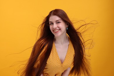 Photo of Portrait of smiling woman on yellow background