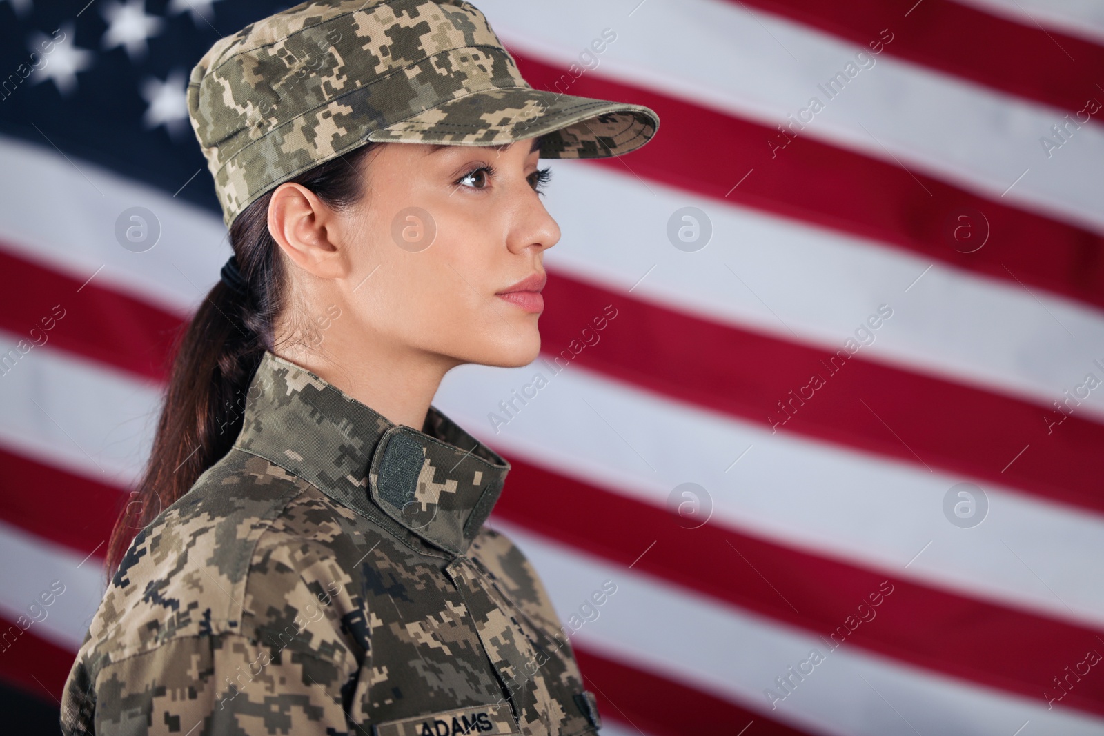 Photo of Female American soldier with flag of USA on background, space for text. Military service