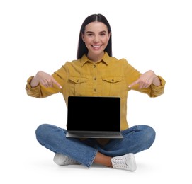 Photo of Happy woman pointing at laptop on white background