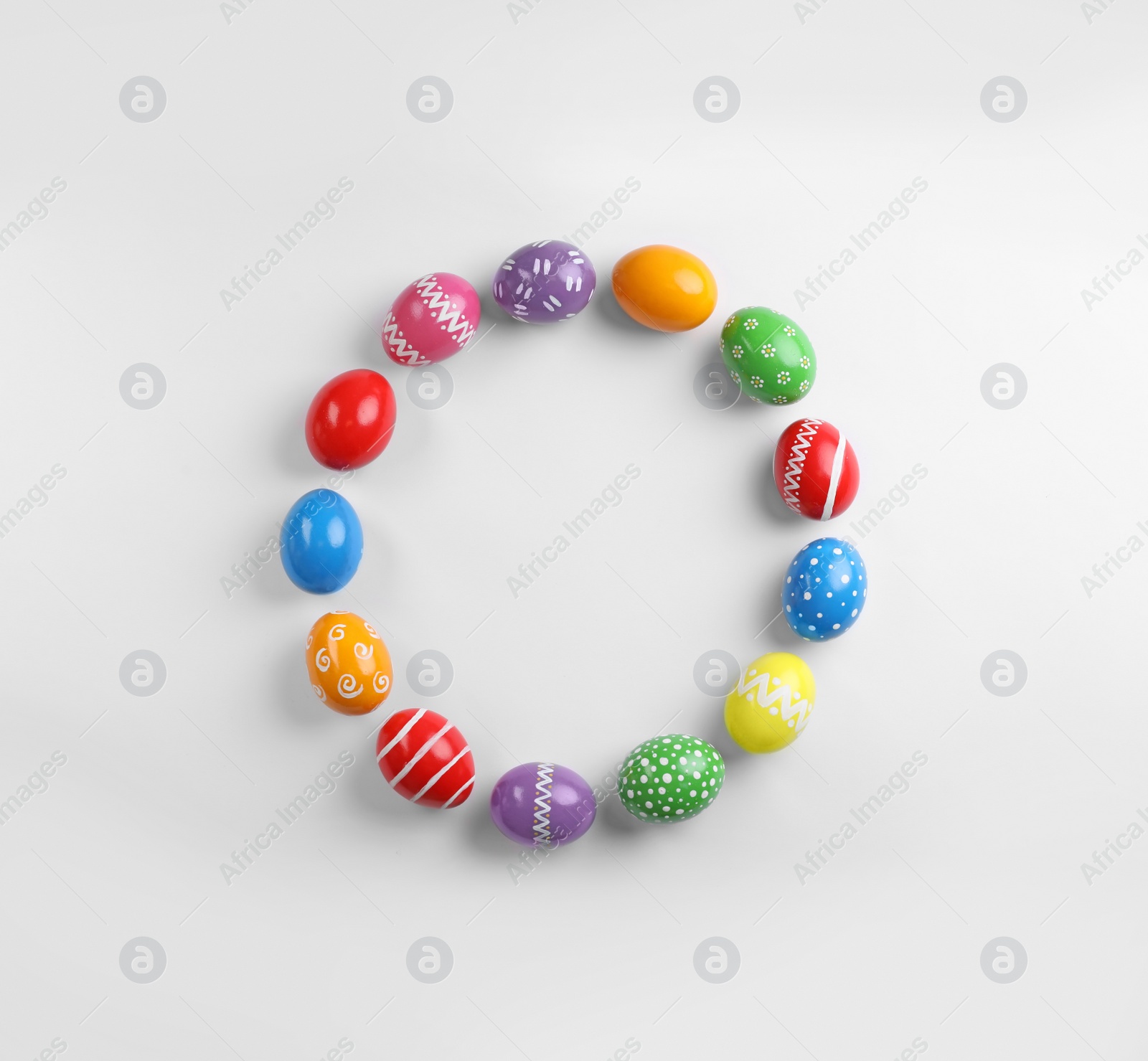 Photo of Decorated Easter eggs and space for text on white background, top view