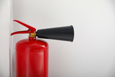 Photo of Fire extinguisher on white background, closeup. Space for text