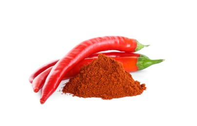 Photo of Fresh chili peppers and paprika powder on white background
