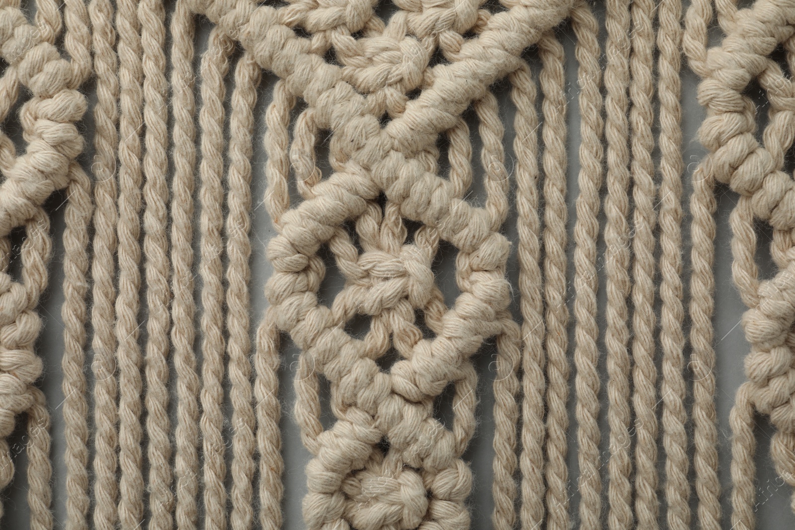 Photo of Texture of beautiful macrame as background, top view. Decorative element