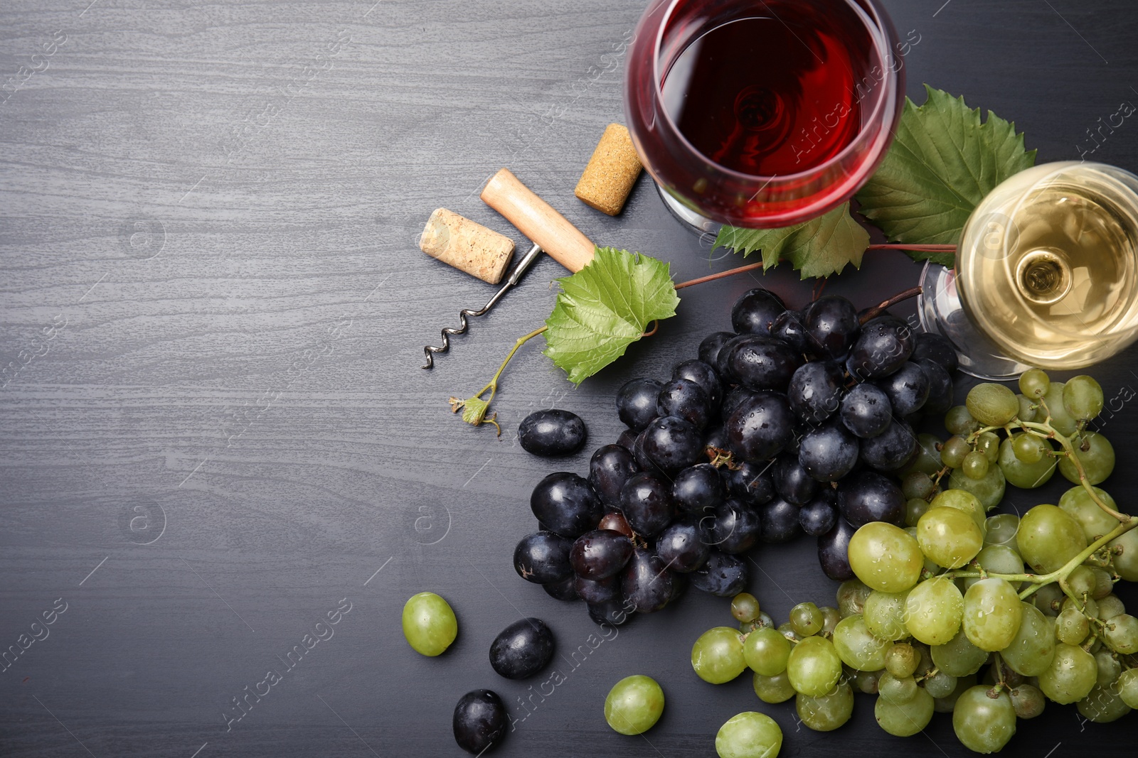 Photo of Flat lay composition with fresh ripe juicy grapes and space for text on wooden background