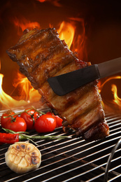 Image of Delicious ribs and vegetables on barbecue grill