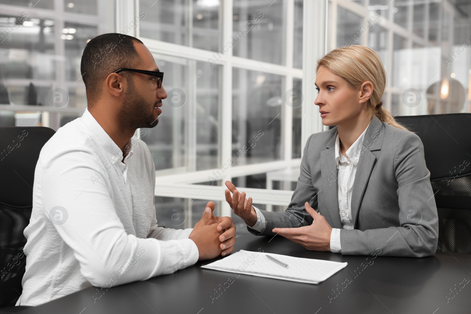 Photo of Lawyers working together at table in office