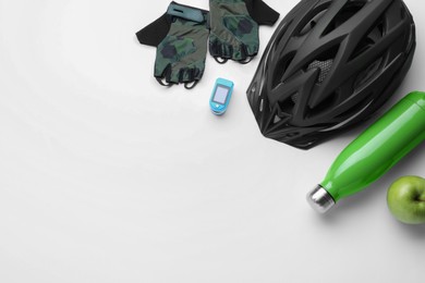 Photo of Flat lay composition with different cycling accessories on white background, space for text