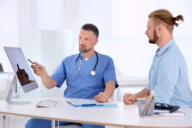 Photo of Man with health problems visiting urologist at hospital