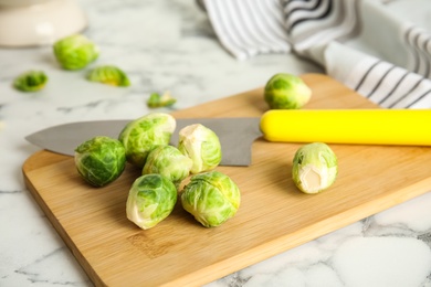 Fresh Brussels sprouts on white marble table, closeup