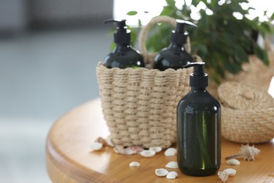 Photo of Soap dispensers and wicker basket on wooden table. Space for text