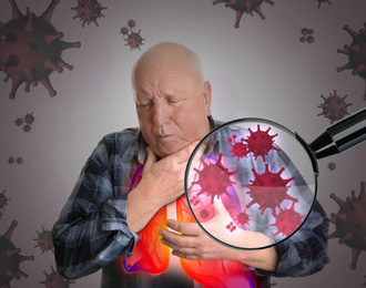 Senior man with diseased lungs surrounded by viruses on grey background