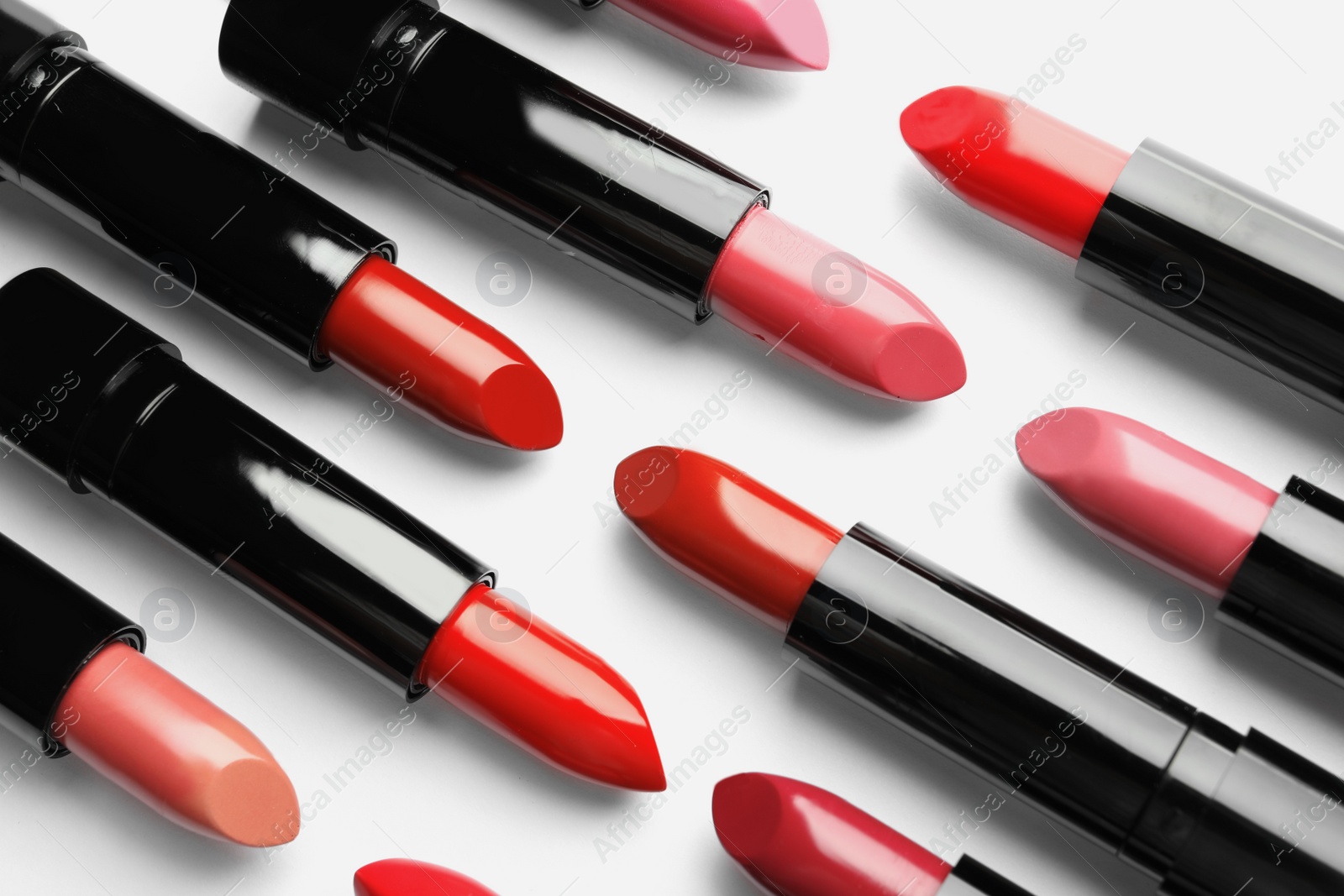 Photo of Flat lay composition with lipsticks on white background