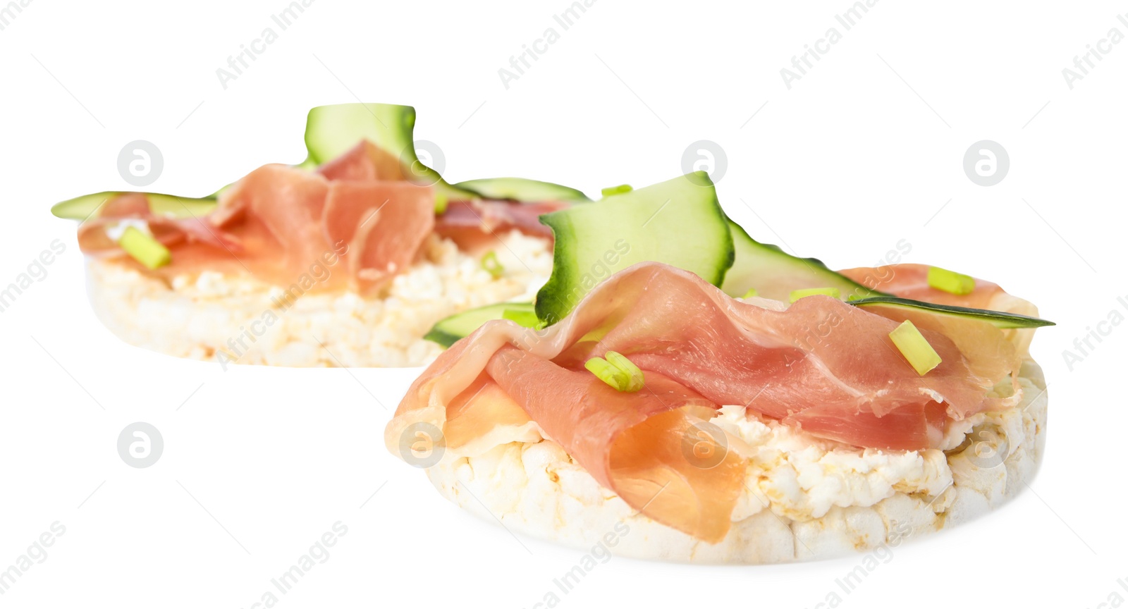 Photo of Puffed rice cakes with prosciutto and cucumber isolated on white