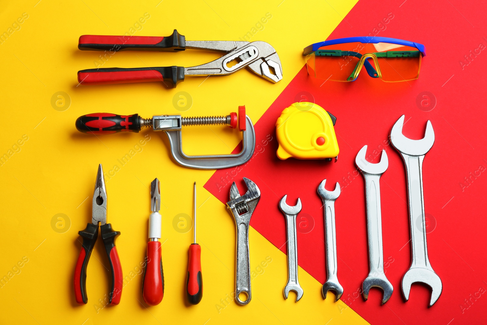 Photo of Flat lay composition with construction tools on color background