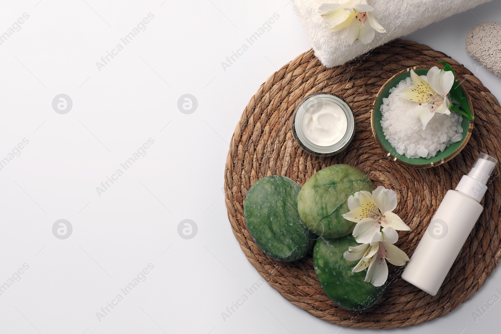 Photo of Flat lay composition with different spa products and beautiful flowers on white table. Space for text