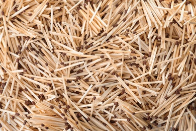 Pile of wooden matches as background, top view