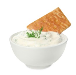 Tasty creamy dill sauce with cracker in bowl isolated on white