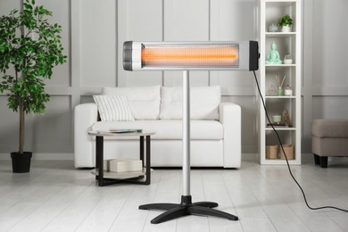 Modern electric infrared heater in cozy room