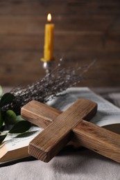 Photo of Cross, Bible and willow branches on table, closeup