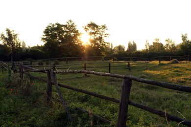 Photo of Picturesque view of countryside with wooden fence in morning