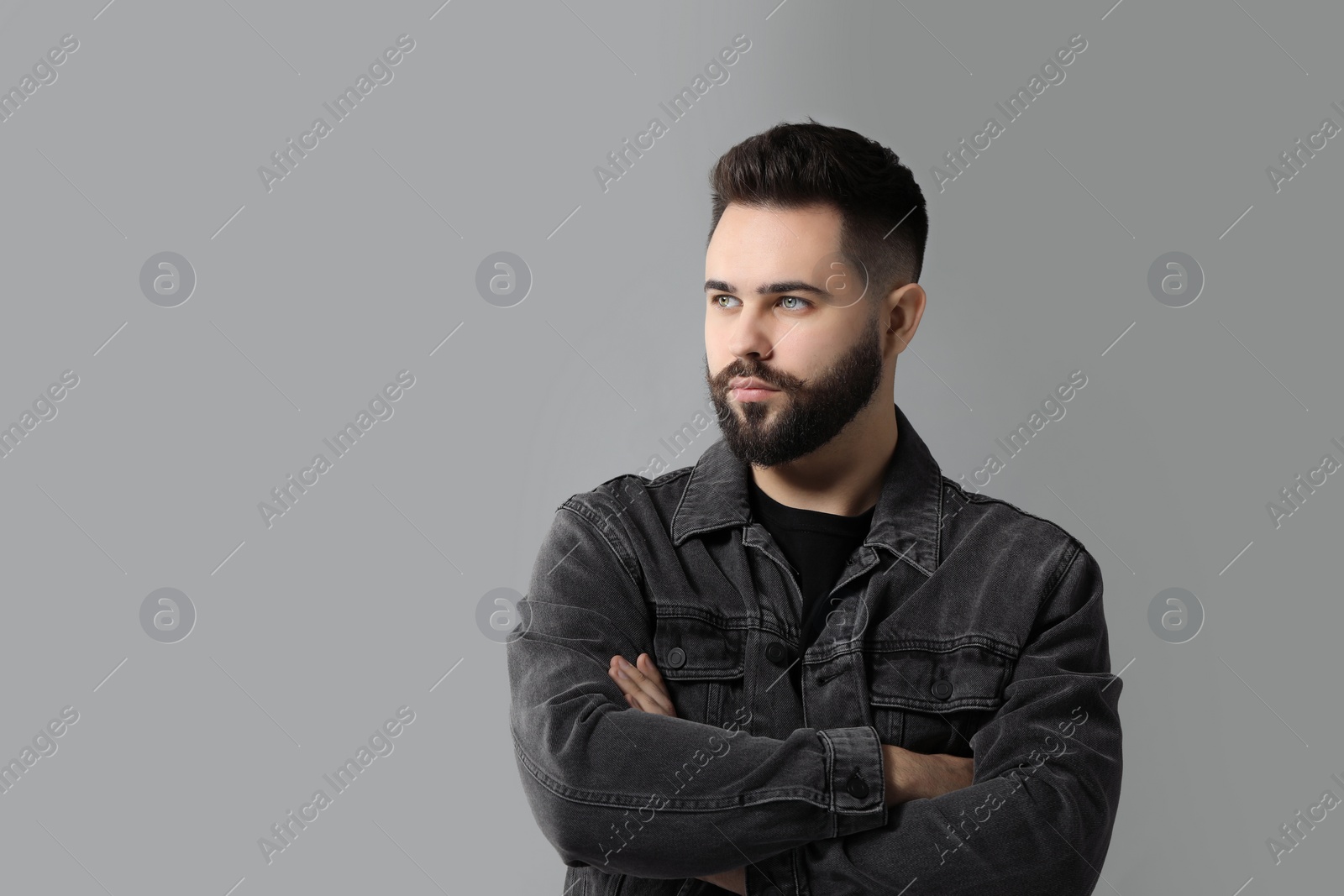 Photo of Portrait of young man with mustache on grey background. Space for text
