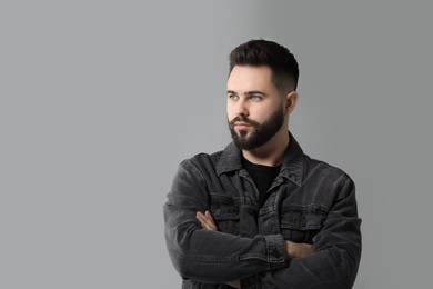 Photo of Portrait of young man with mustache on grey background. Space for text