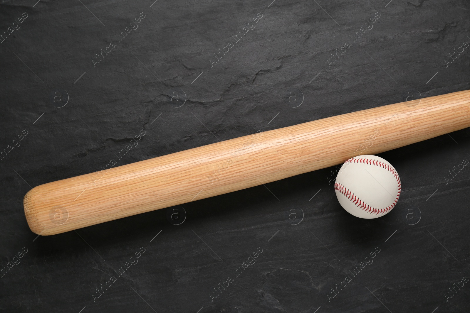 Photo of Baseball bat and ball on black background, top view. Sports equipment