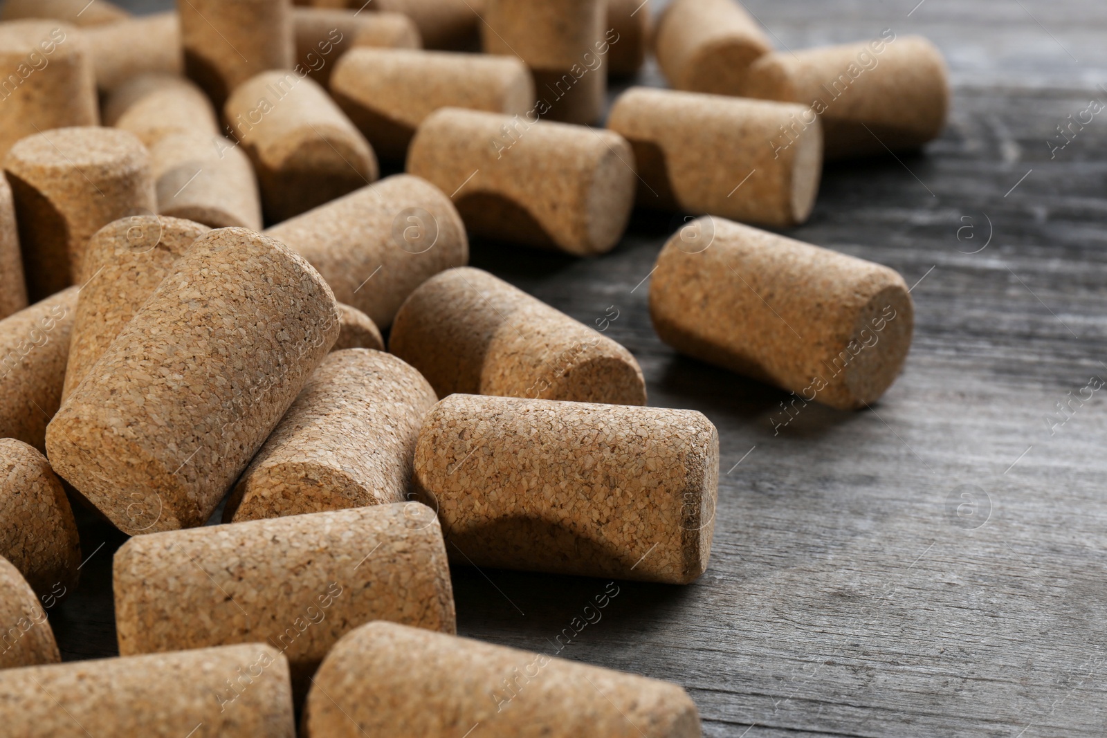 Photo of Wine bottle corks on wooden table, closeup