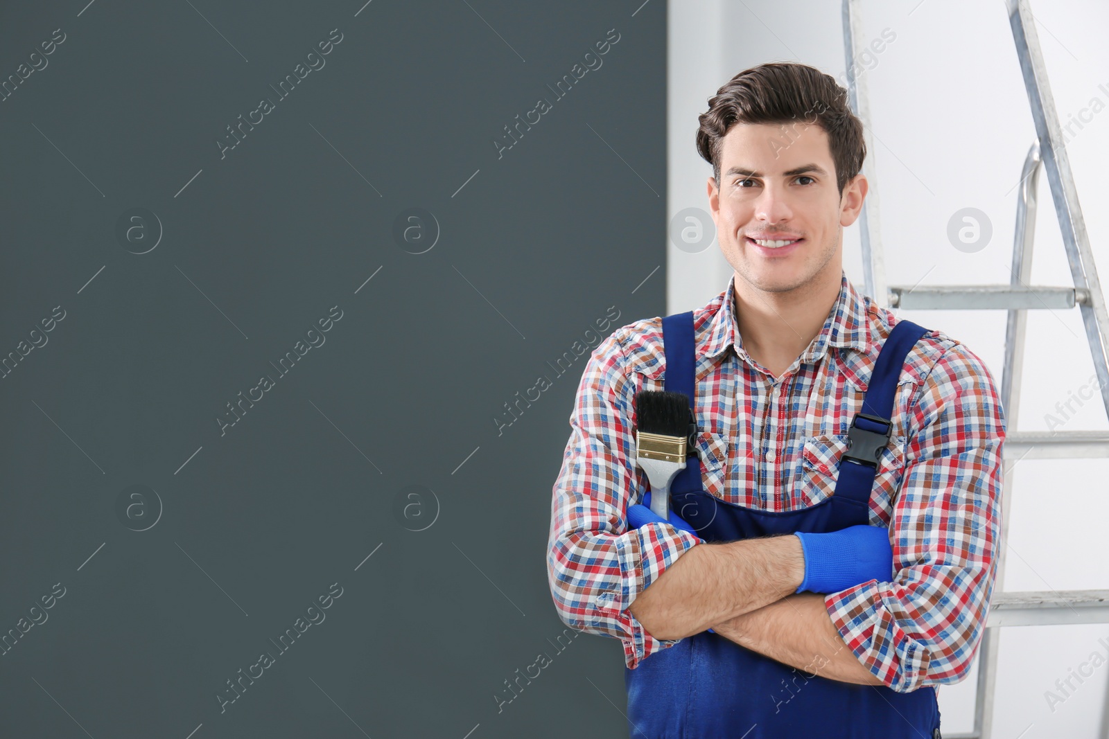 Photo of Portrait of male decorator with brush indoors