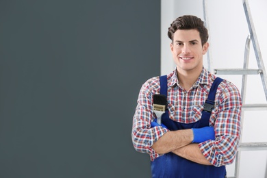 Photo of Portrait of male decorator with brush indoors