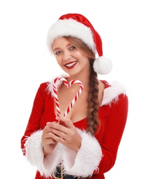 Beautiful Santa girl with candy canes on white background. Christmas eve