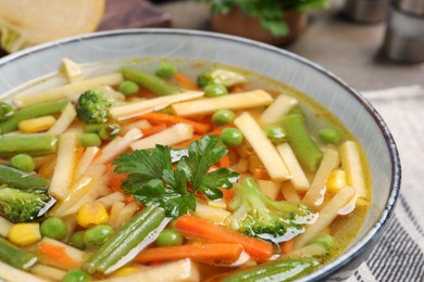 Photo of Bowl of delicious turnip soup on table, closeup view