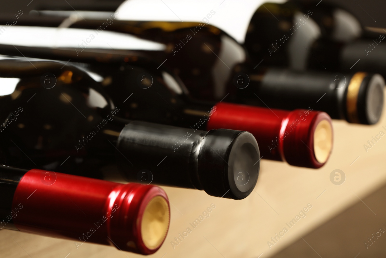 Photo of Bottles of different wines, closeup. Expensive collection