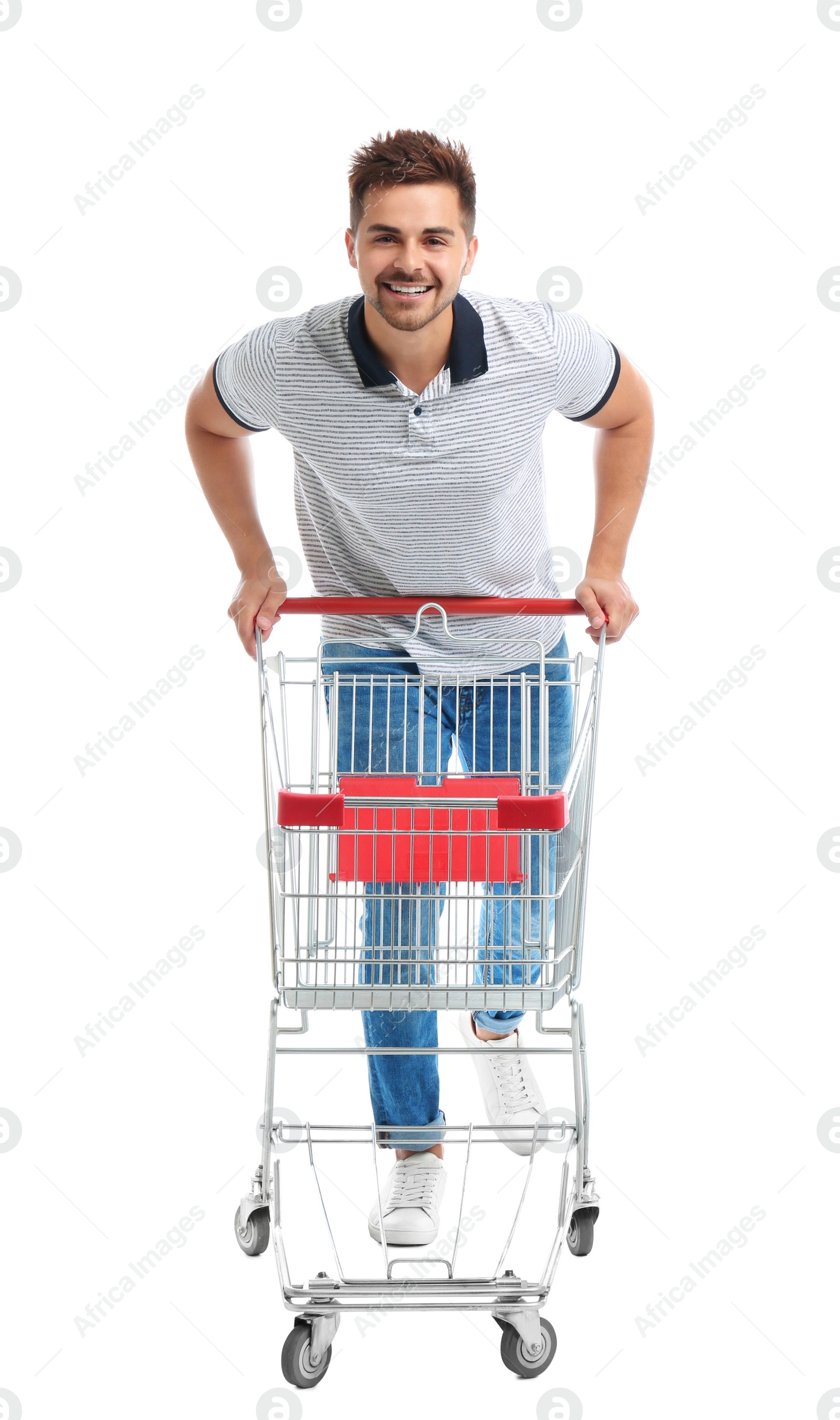 Photo of Young man with empty shopping cart on white background