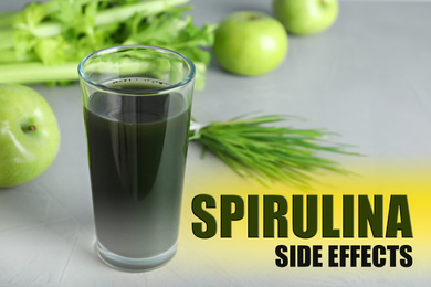 Image of Glass of spirulina drink on grey background. Side effects 