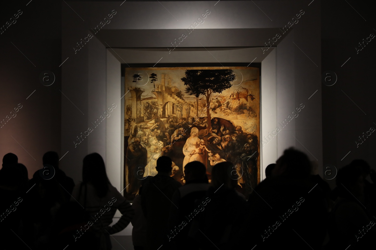 Photo of Florence, Italy - February 8, 2024: Visitors looking at famous painting "Adoration of the Magi" by Leonardo da Vinci at Uffizi gallery