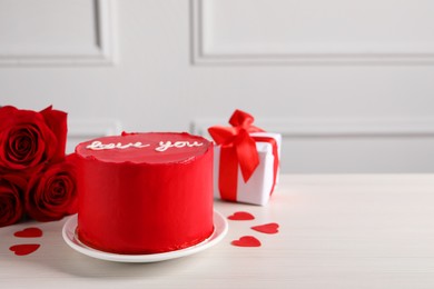 Photo of Bento cake with text Love You, roses, paper hearts and gift box on white wooden table, space for text. St. Valentine's day surprise