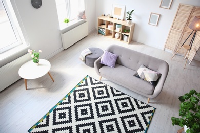 Living room interior with comfortable sofa, view through CCTV camera