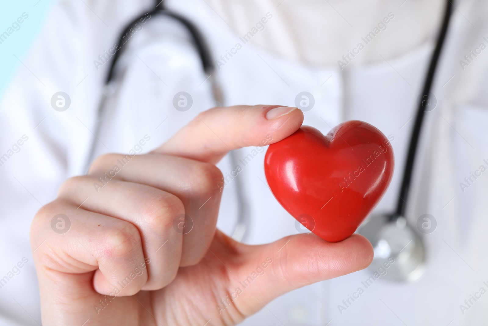 Photo of Doctor with red decorative heart, closeup view