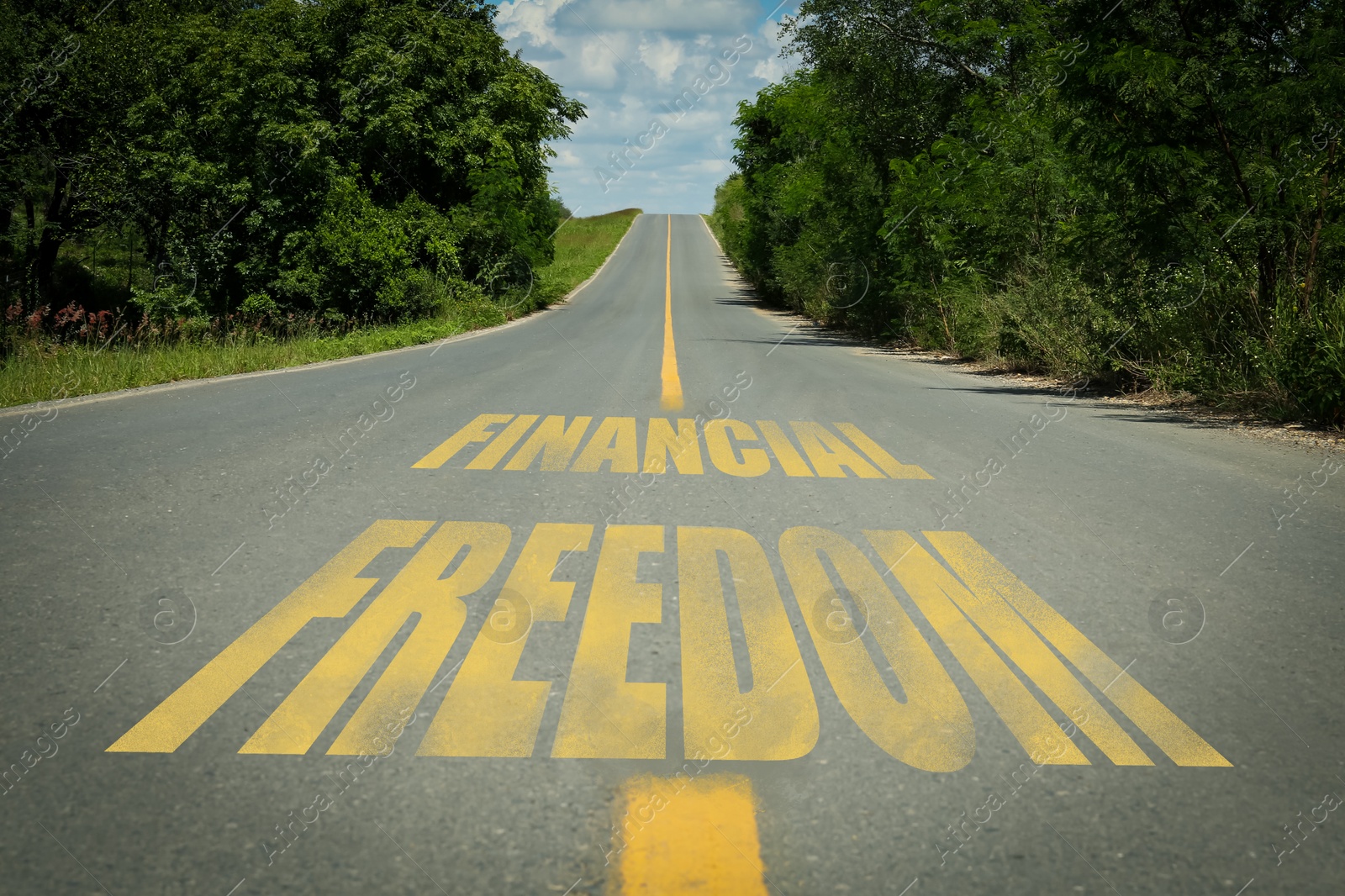 Image of Way to financial freedom. Words on asphalt road