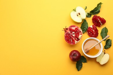 Photo of Flat lay composition with Rosh Hashanah holiday attributes on yellow background. Space for text