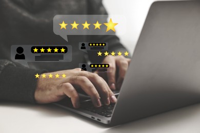 Image of Man leaving service feedback using laptop at table, closeup. Reviews and stars near device