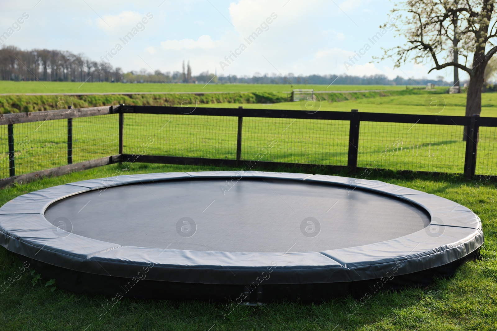 Photo of Shoes near trampoline on green grass outdoors