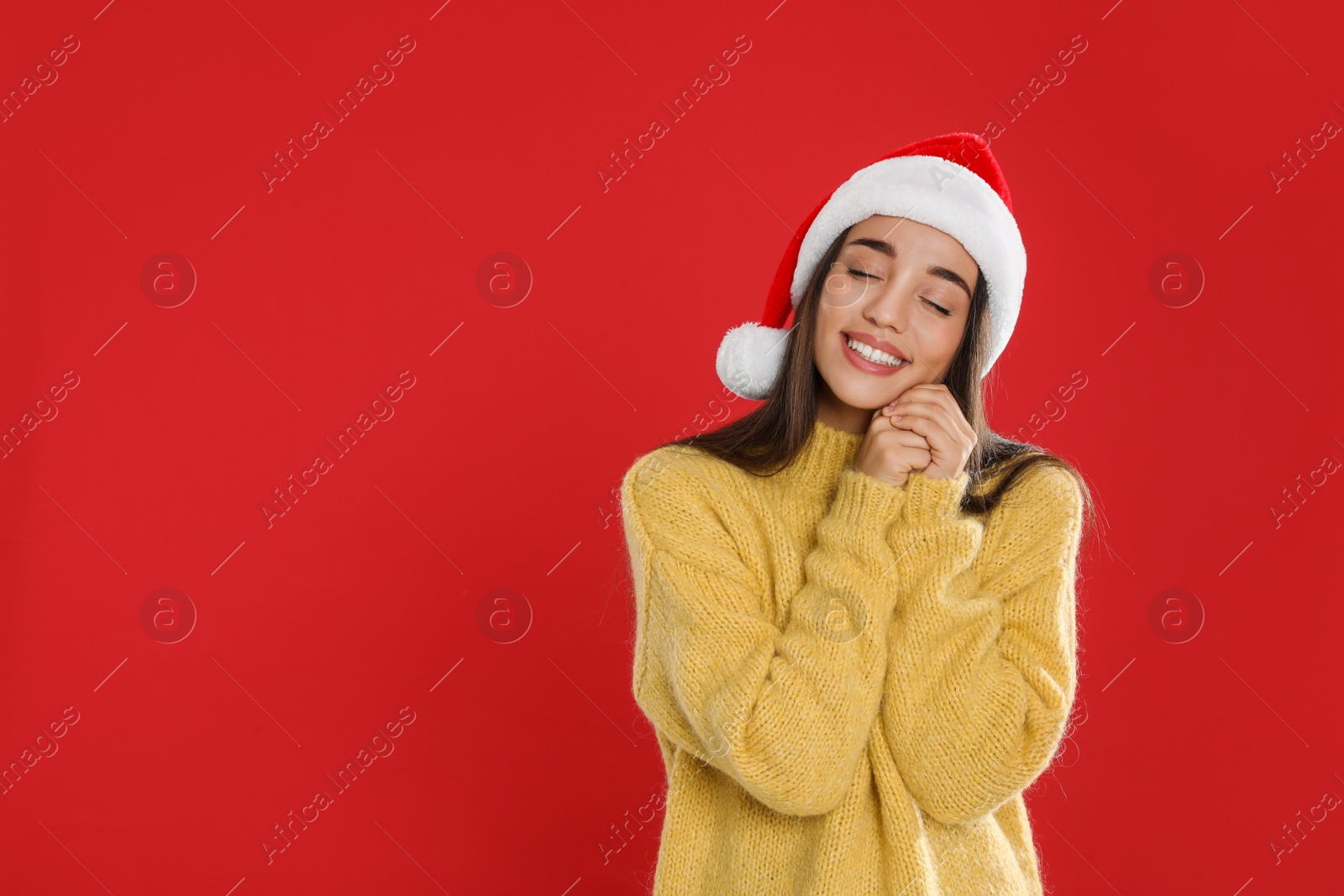 Photo of Happy woman in Santa hat on red background, space for text. Christmas countdown