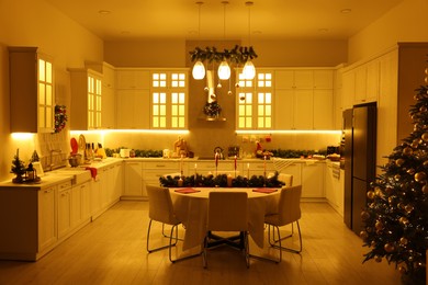 Photo of Cozy spacious kitchen decorated for Christmas. Interior design