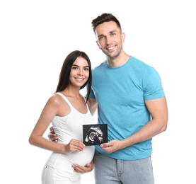 Happy young family with ultrasound picture on white background