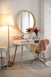 Stylish room interior with dressing table and mirror