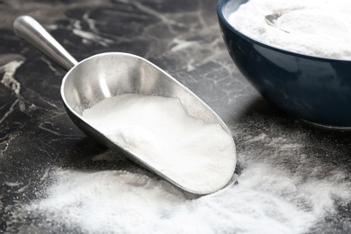 Photo of Kitchenware with baking soda on grey background