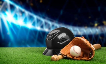 Image of Baseball bat, glove, helmet and ball on grass at stadium. Banner design with space for text